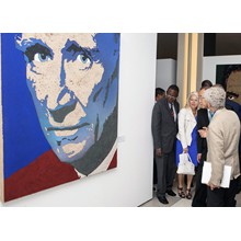 United Nations Secretary-General Ban Ki-moon listens to the fresco painter and curator  Fabrizio Ruggiero introducing the portrait of Sebastiao Salgado (Brazil), part of the exhibit " The transformative Power of Art" at United Nations Visitors Lobby, New York. 30 June   2015.