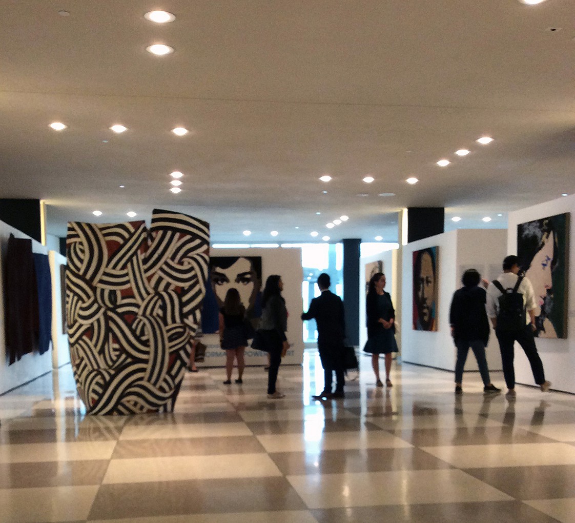 Visitors encountering works by Fabrizio Ruggiero in an institutional exhibition space